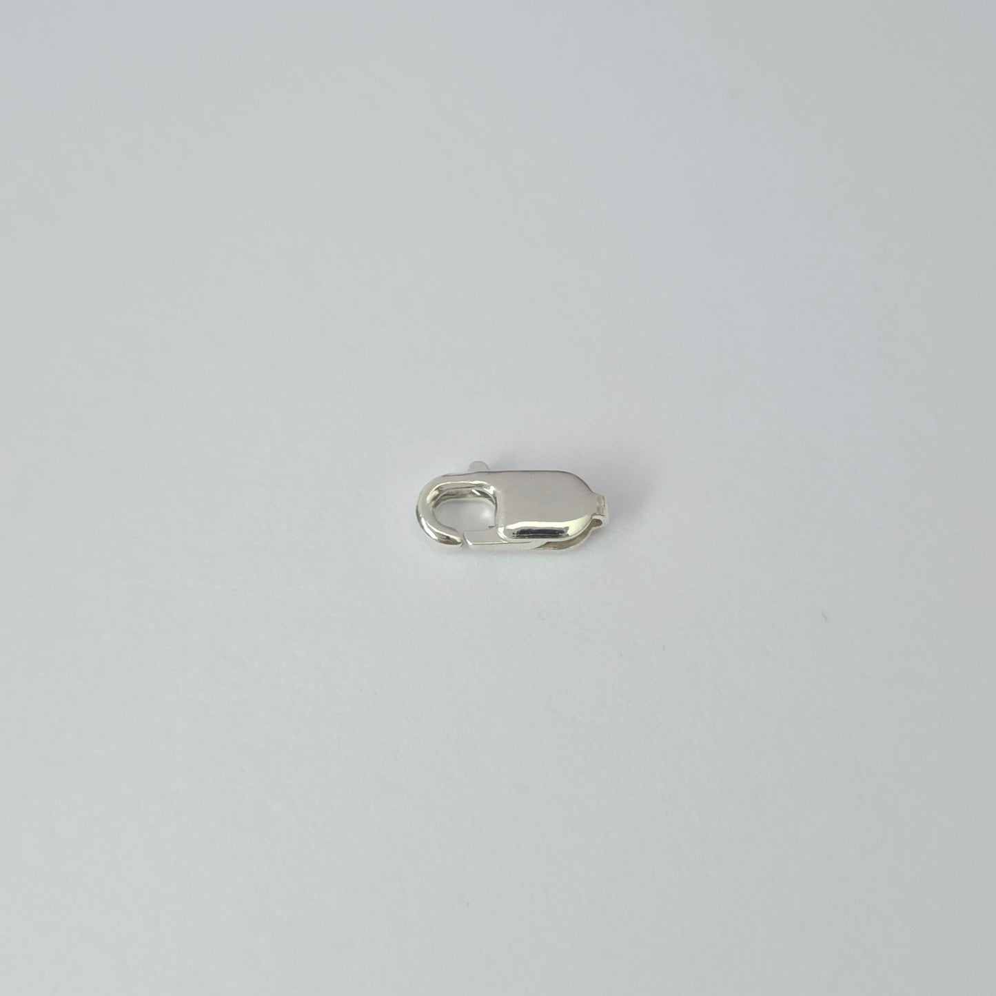 Silver clasp on a light gray background