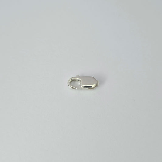 Silver clasp on a light gray background