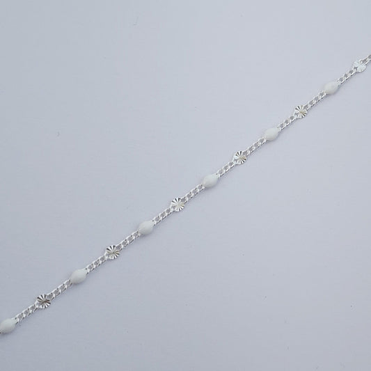 Silver bracelet on a light gray background