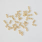 Gold infinity-shaped connectors on a light gray background