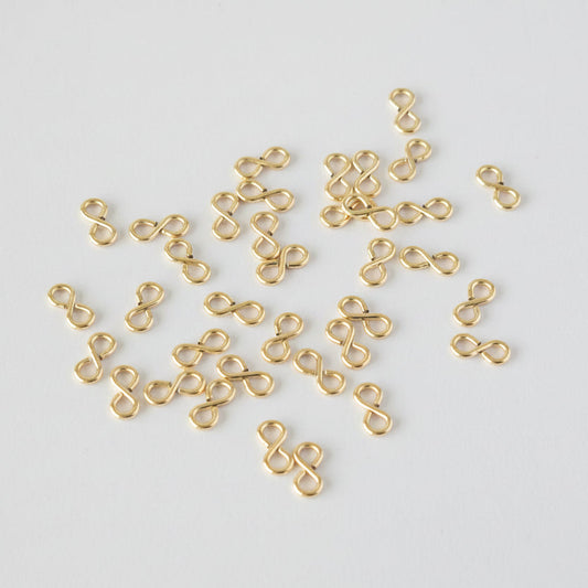 Gold infinity-shaped connectors on a light gray background