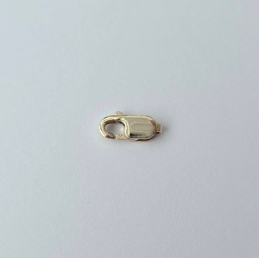 Gold clasp on a light gray background
