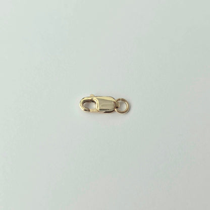 Gold clasp on a light gray background