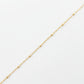 Gold chain on a light gray background