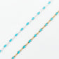 Two gold and silver beaded necklaces on a light gray background