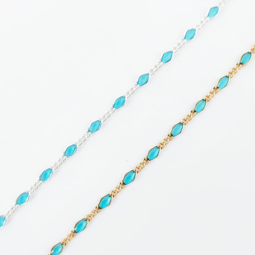 Two gold and silver beaded necklaces on a light gray background
