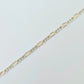 Gold and silver chain on a light gray background