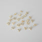 Gold heart-shaped pendants on a gray background