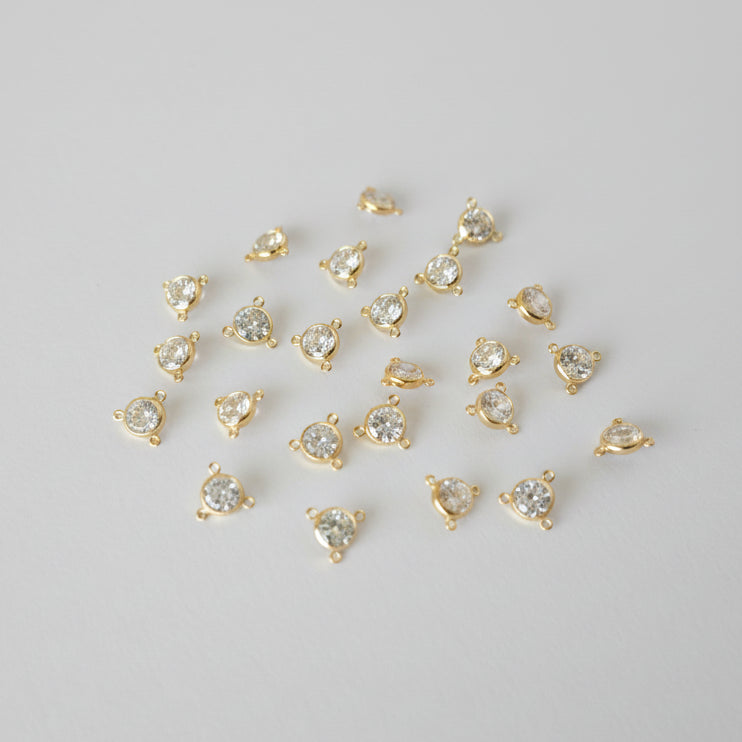 Gold heart-shaped pendants on a gray background