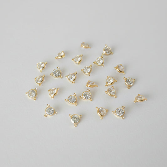 Gold heart-shaped pendants on a gray background