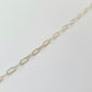 Silver chain necklace on a light gray background