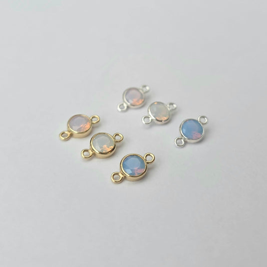 Jewelry components with opal stones on a light gray background