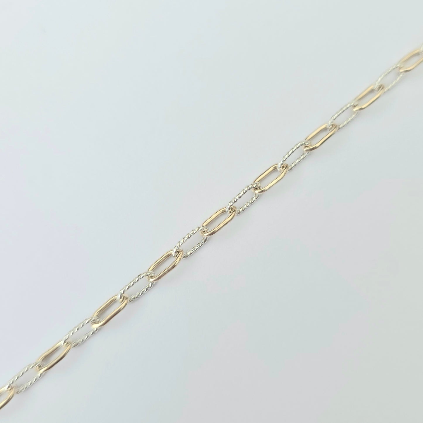 Gold chain on a light gray background