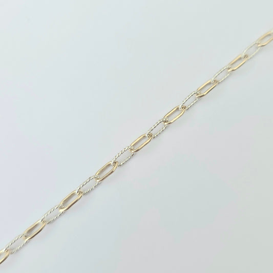 Gold chain on a light gray background