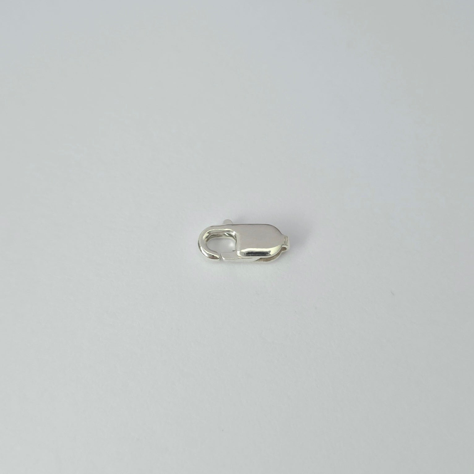 Silver clasp on a light gray background