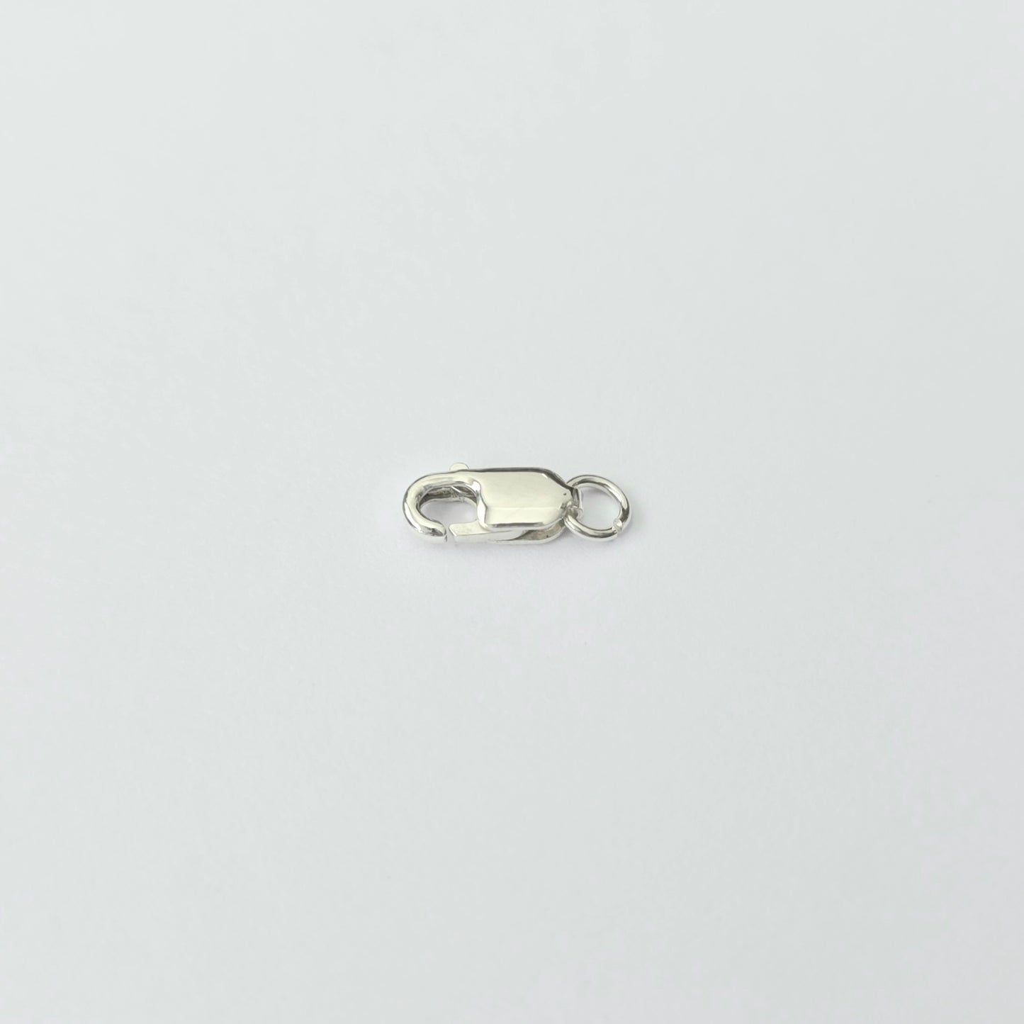 Silver clasp on a light gray background