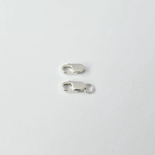 Two silver lobster clasps on a white background
