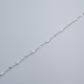 Silver bracelet on a light gray background