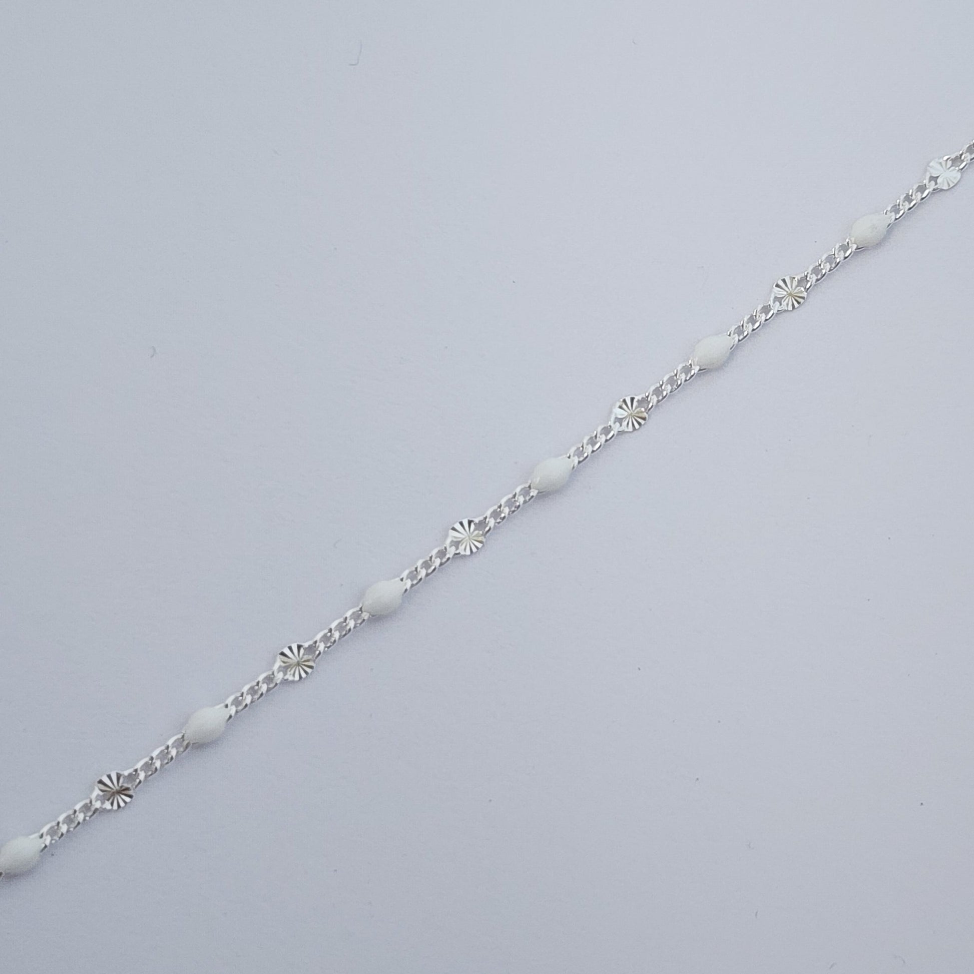 Silver bracelet on a light gray background