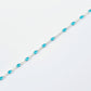 Turquoise beaded bracelet on a light gray background
