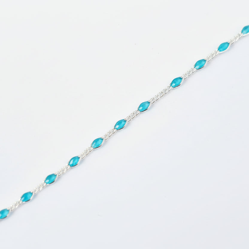 Turquoise beaded bracelet on a light gray background