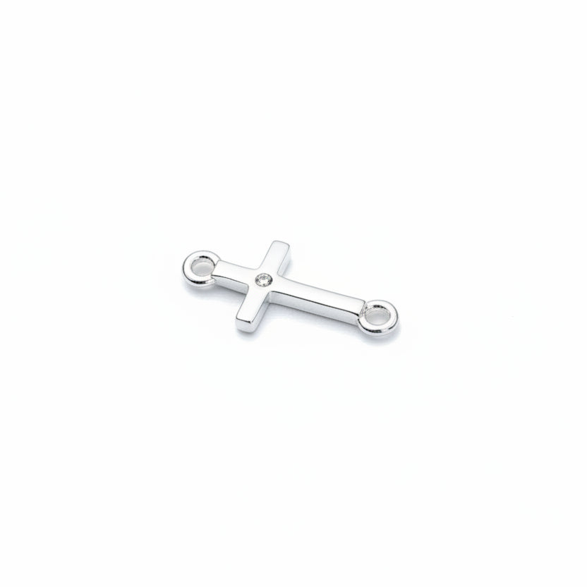Silver cross pendant on a light gray background