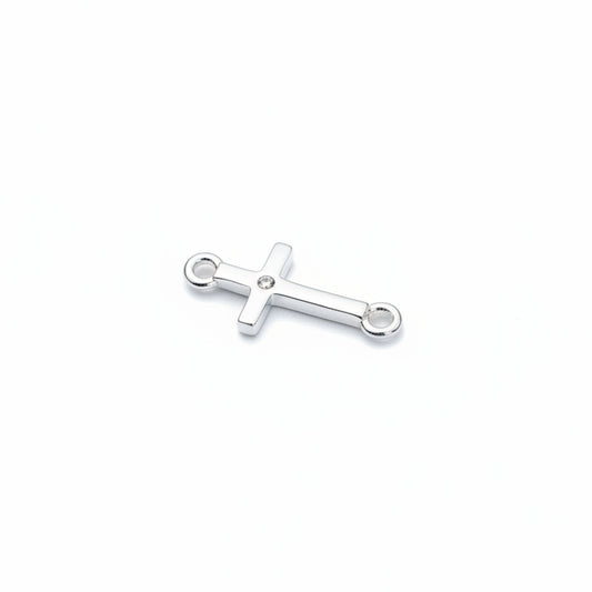 Silver cross pendant on a light gray background
